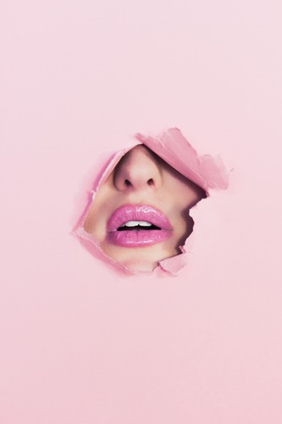 female-lips-on-a-pink-background